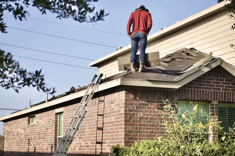 Professional roofer working on a residential roof in Cedar Valley College